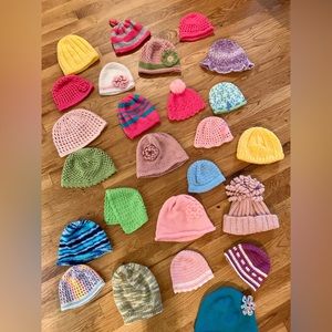 Hand-knit and crocheted hats, ranging infant to child/teen size.
